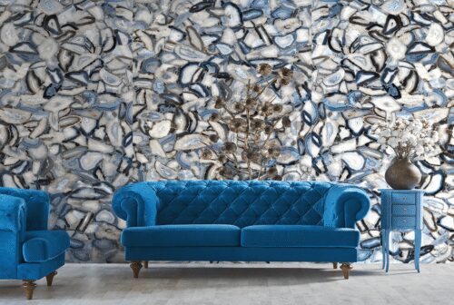 Blue velvet sofa against agate patterned wall